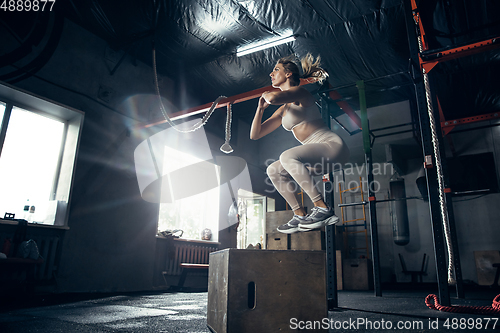 Image of The female athlete training hard in the gym. Fitness and healthy life concept.