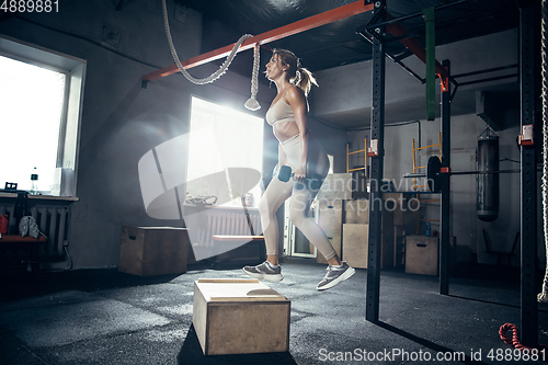 Image of The female athlete training hard in the gym. Fitness and healthy life concept.