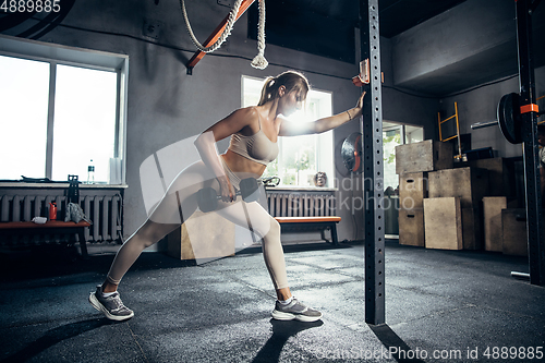 Image of The female athlete training hard in the gym. Fitness and healthy life concept.