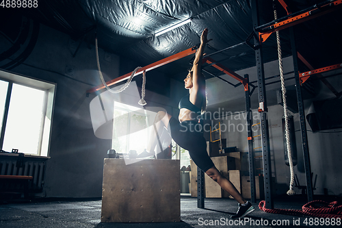 Image of The female athlete training hard in the gym. Fitness and healthy life concept.
