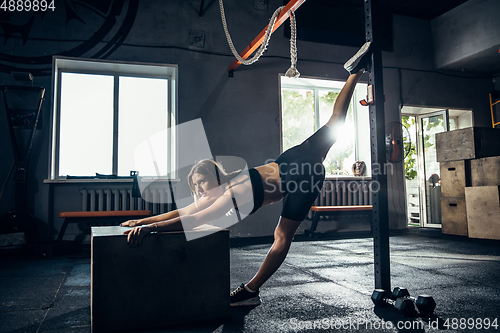 Image of The female athlete training hard in the gym. Fitness and healthy life concept.