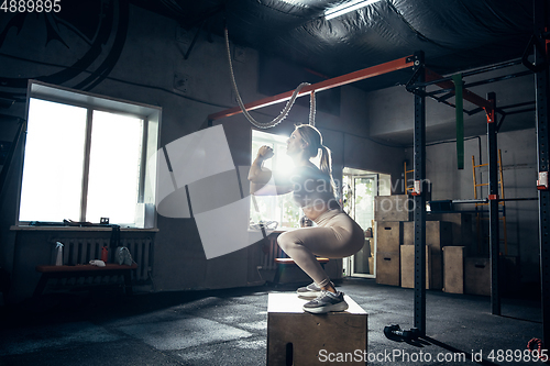 Image of The female athlete training hard in the gym. Fitness and healthy life concept.