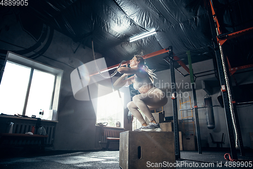 Image of The female athlete training hard in the gym. Fitness and healthy life concept.