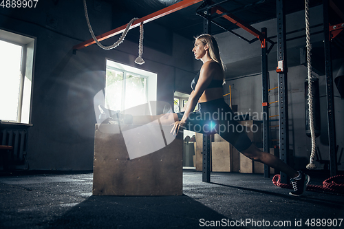 Image of The female athlete training hard in the gym. Fitness and healthy life concept.