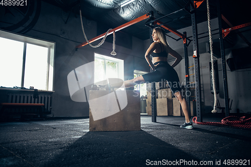 Image of The female athlete training hard in the gym. Fitness and healthy life concept.