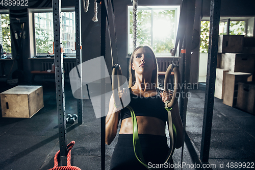 Image of The female athlete training hard in the gym. Fitness and healthy life concept.