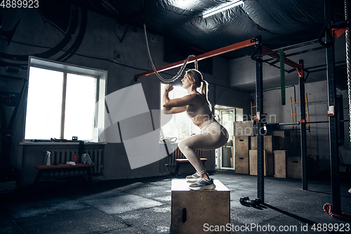 Image of The female athlete training hard in the gym. Fitness and healthy life concept.