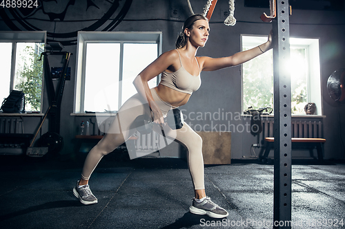 Image of The female athlete training hard in the gym. Fitness and healthy life concept.