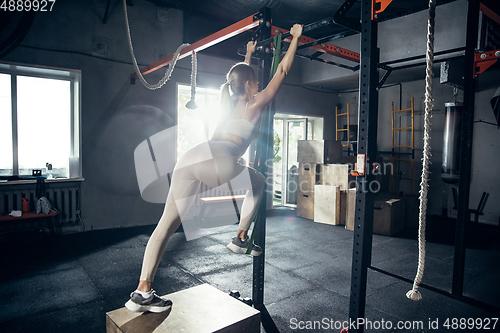 Image of The female athlete training hard in the gym. Fitness and healthy life concept.