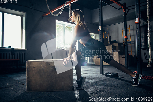 Image of The female athlete training hard in the gym. Fitness and healthy life concept.
