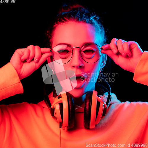 Image of Caucasian woman\'s portrait isolated on studio background in neon light