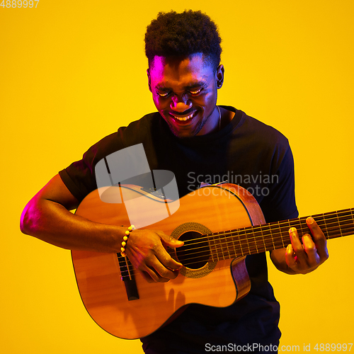 Image of Caucasian man\'s portrait isolated on studio background in neon light
