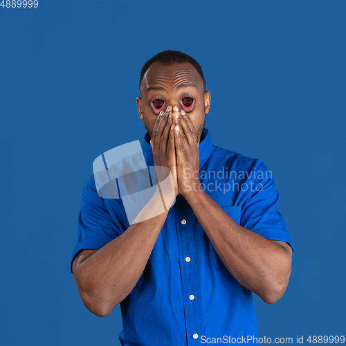 Image of African man\'s portrait isolated on studio background, monochrome