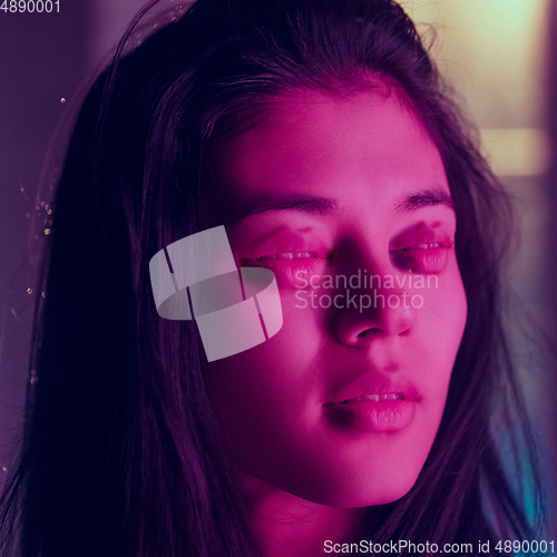 Image of Caucasian woman\'s portrait isolated on studio background in neon light