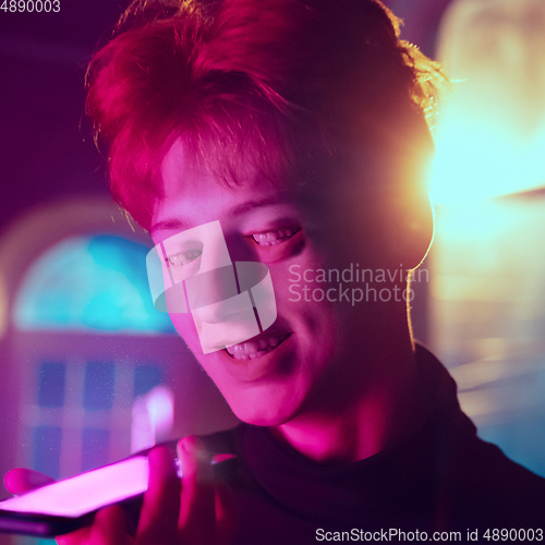 Image of Caucasian man\'s portrait isolated on studio background in neon light