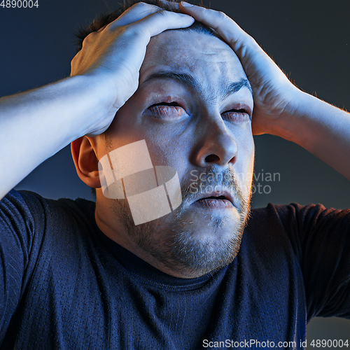 Image of Caucasian man\'s portrait isolated on studio background in neon light