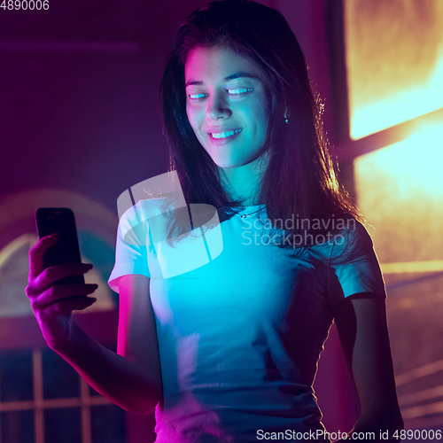 Image of Caucasian woman\'s portrait isolated on studio background in neon light