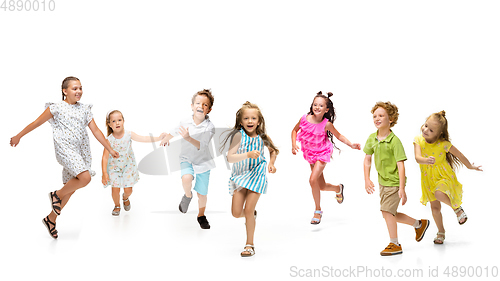 Image of Happy little caucasian kids jumping and running isolated on white background