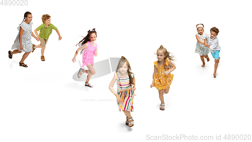 Image of Happy little caucasian kids jumping and running isolated on white background