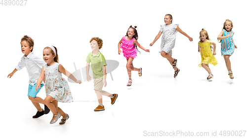 Image of Happy little caucasian kids jumping and running isolated on white background
