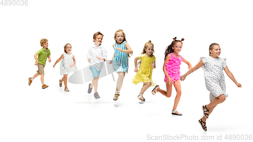 Image of Happy little caucasian kids jumping and running isolated on white background