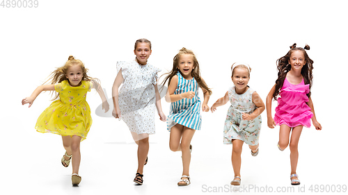 Image of Happy little caucasian kids jumping and running isolated on white background