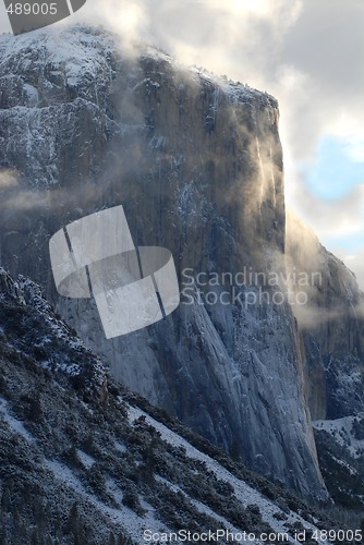 Image of El Capitan illuminated by early morning stormy skies