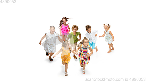 Image of Happy little caucasian kids jumping and running isolated on white background