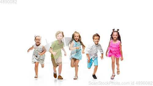Image of Happy little caucasian kids jumping and running isolated on white background