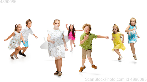 Image of Happy little caucasian kids jumping and running isolated on white background