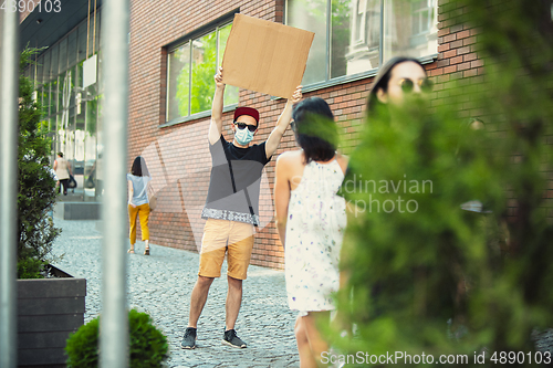 Image of Dude with sign - man stands protesting things that annoy him