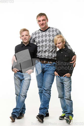 Image of Full length portrait of father and two sons in casual clothes, isolated on white background