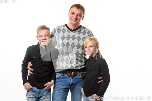 Image of Half-length portrait of a father and two sons in casual clothes, isolated on a white background