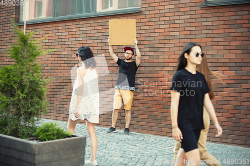 Image of Dude with sign - man stands protesting things that annoy him