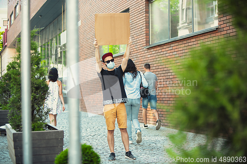 Image of Dude with sign - man stands protesting things that annoy him