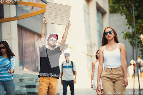 Image of Dude with sign - man stands protesting things that annoy him