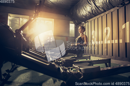 Image of The female athlete training hard in the gym. Fitness and healthy life concept.