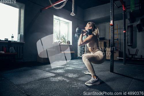 Image of The female athlete training hard in the gym. Fitness and healthy life concept.