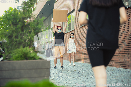 Image of Dude with sign - man stands protesting things that annoy him