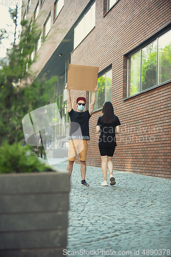 Image of Dude with sign - man stands protesting things that annoy him