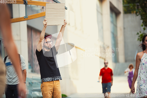 Image of Dude with sign - man stands protesting things that annoy him