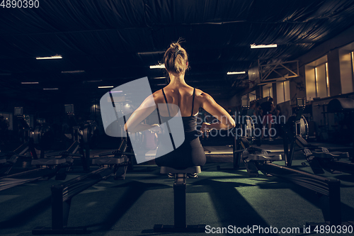 Image of The female athlete training hard in the gym. Fitness and healthy life concept.