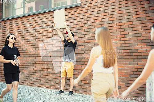 Image of Dude with sign - man stands protesting things that annoy him