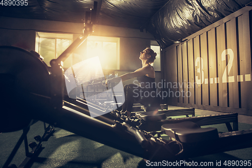 Image of The female athlete training hard in the gym. Fitness and healthy life concept.