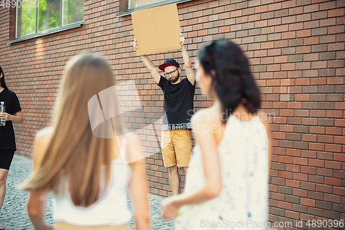 Image of Dude with sign - man stands protesting things that annoy him