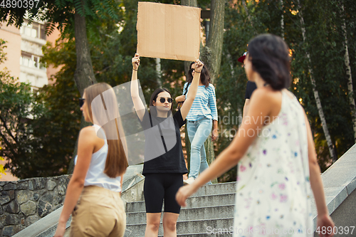 Image of Dude with sign - woman stands protesting things that annoy her