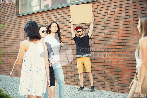 Image of Dude with sign - man stands protesting things that annoy him