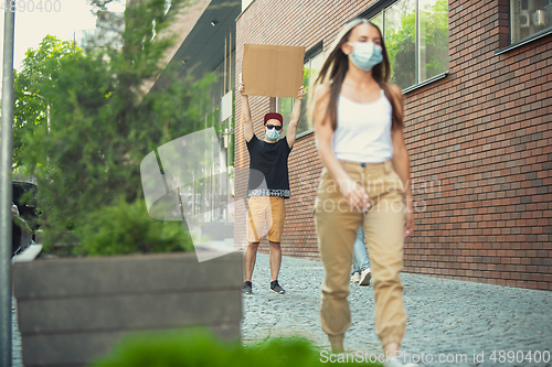 Image of Dude with sign - man stands protesting things that annoy him