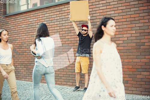 Image of Dude with sign - man stands protesting things that annoy him