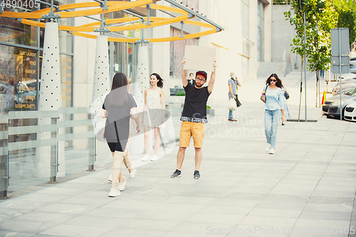 Image of Dude with sign - man stands protesting things that annoy him